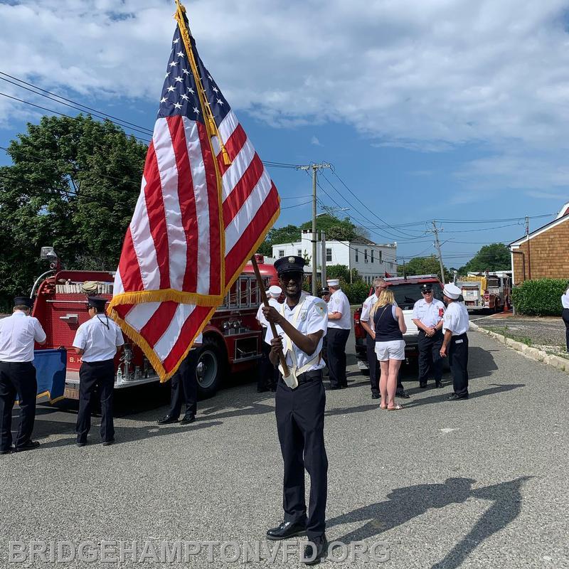 Thierry marches in parade with the flag. 