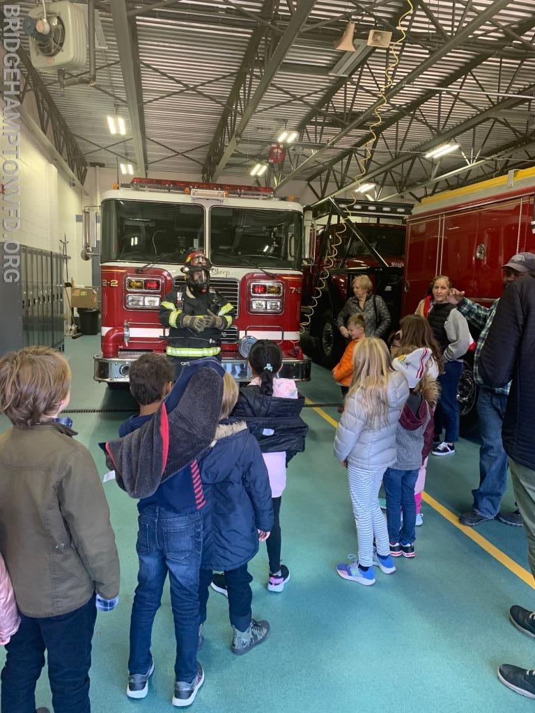 Firefighter Zach Broadmeadow tells the students about turn out gear and some of the other very important equipment in our fire house. . 