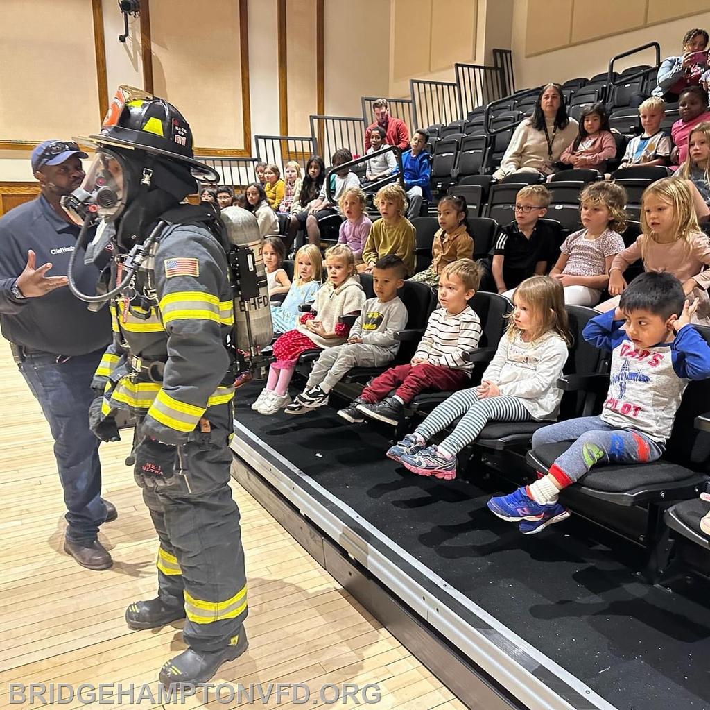 Firefighter Christian Sanchez and Chief Nick Hemby talk to the students about fire gear and fire safety. 