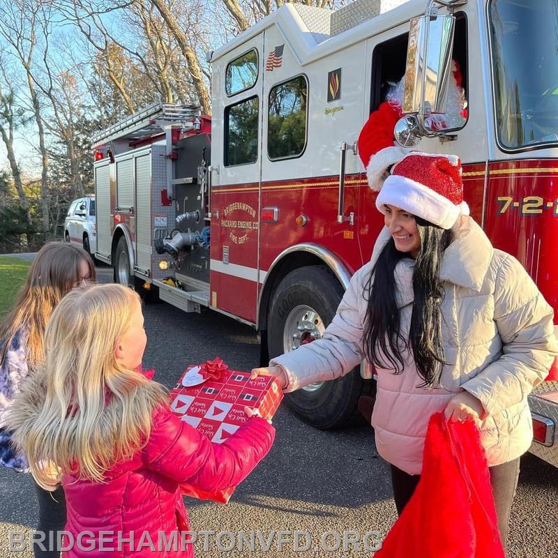 Bridgehampton Fire Department helped Santa deliver some early Christmas presents to member's children and grandchildren on Sunday December 12, 2021. Santa's helper Mafe Lopez was hard at work!